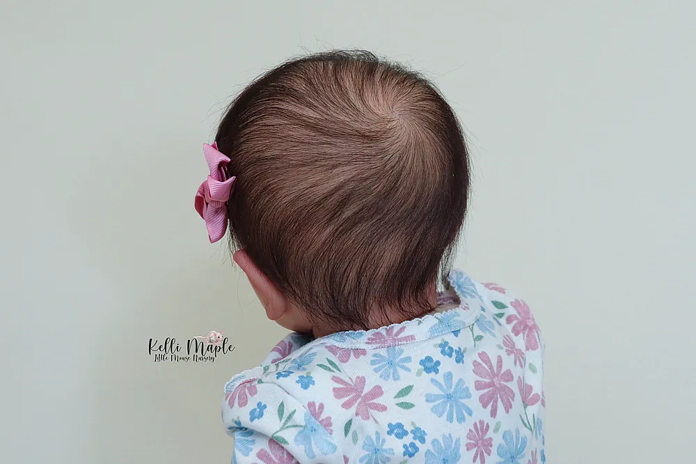 Asia 25 inch reborn baby doll with rooted black mohair hair